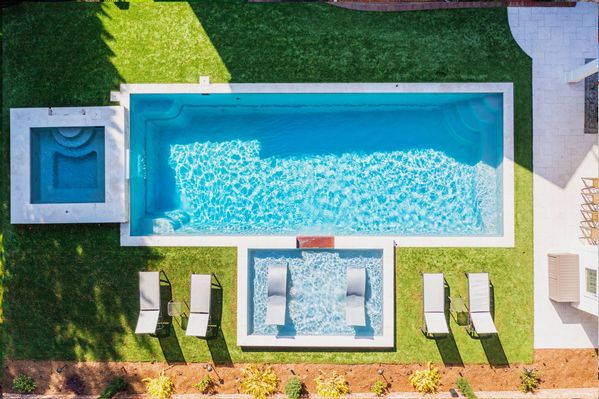River Pools R40  SS08 with spillway  TL15 with spillway in Granite Gray with bubblers turf patio and natural stone coping 2