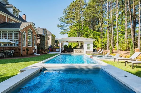 River Pools R40  SS08 with spillway  TL15 with spillway in Granite Gray with bubblers turf patio and natural stone coping 9