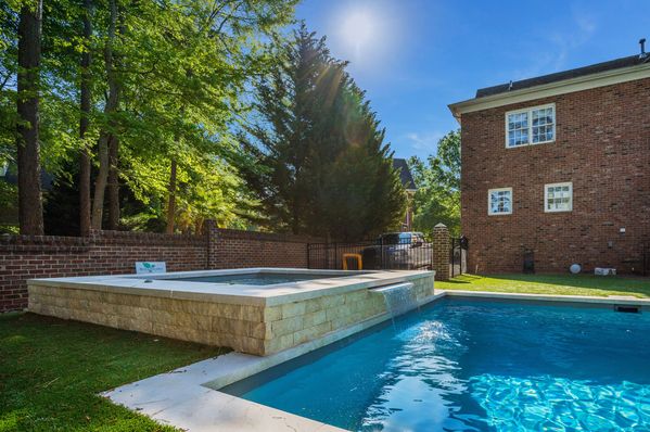 River Pools R40  SS08 with spillway  TL15 with spillway in Granite Gray with bubblers turf patio and natural stone coping 7