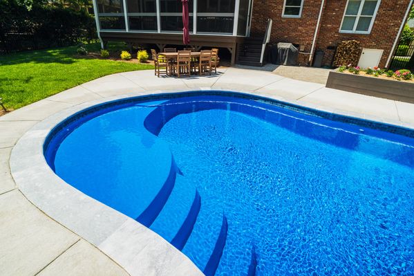 River Pools C40 in Maya Shimmer with brushed concrete and natural stone coping 17